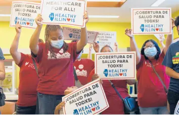  ?? SHAFKAT ANOWAR/AP ?? Members of the Health Illinois coalition in Chicago’s Pilsen neighborho­od celebrate the extension Tuesday of state health insurance coverage to immigrants 55 and over living in the country illegally. The state was the first to offer a program for seniors.