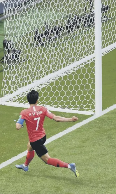  ??  ?? 0 Son Heung-min rolls the ball into an empty net in the sixth minute of added time to to seal Germany’s