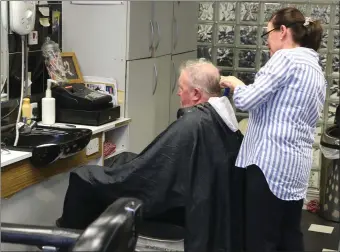  ??  ?? Geraldine Flanagan at work in the barbers.