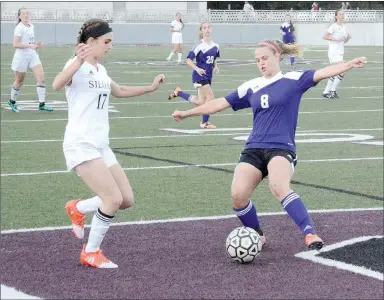  ?? Graham Thomas/Siloam Sunday ?? El Dorado’s Landrey Harrell plays the ball as Siloam Springs sophomore Hadley Crenshaw converges on the play Thursday during the 6A-West Conference Tournament semifinals at Panther Stadium. Siloam Springs defeated El Dorado 7-1.