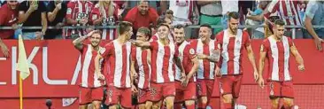  ??  ?? PEMAIN Girona meraikan gol ketika menentang Atletico Madrid di Sepanyol.