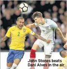  ??  ?? John Stones beats Dani Alves in the air