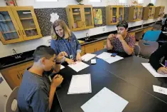  ??  ?? Christy Krenek, an eighth grade science teacher, checks 13-year-old Bobby Montoya’s schedule and informs him that he is in the wrong class on the first day.