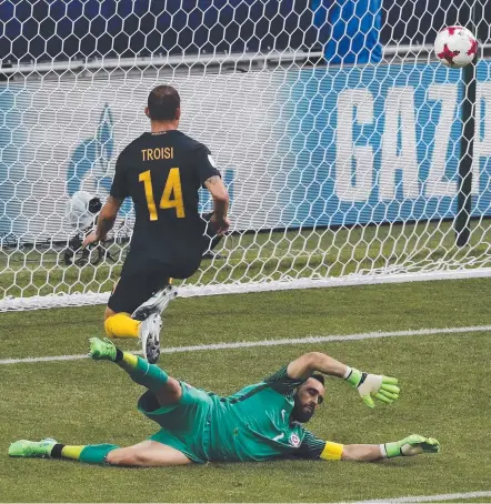  ??  ?? Man of the match James Troisi gets the ball past Chile goalkeeper Claudio Andres Bravo Munoz to score for Australia.