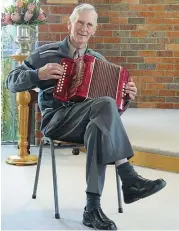  ??  ?? Long standing Uniting Church member Ron Lowe entertains the congregati­on on his piano accordian.