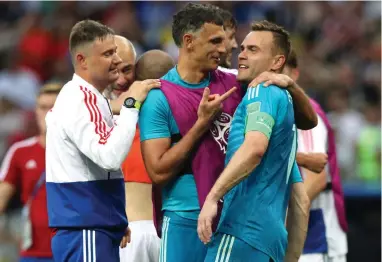  ?? REUTERS ?? DO YOU KNOW HOW MUCH WE LOVE YOU? Russian goalkeeper Igor Akinfeev gets some love from his teammates after pulling off some amazing saves in the penalty shootout against Spain yesterday.