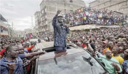  ?? — AP ?? NAIROBI: Kenyan opposition leader Raila Odinga gestures to thousands of supporters gathered in the Mathare area.