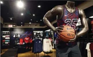  ?? MARY ALTAFFER, THE ASSOCIATED PRESS ?? Foot Locker’s redesigned Manhattan flagship store in New York includes the House of Hoops display area.