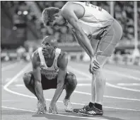  ?? CP PHOTO ?? Canada’s Damian Warner and Australia’s Cedric Dubler react after their heat in the 400m of the decathlon at Carrara Stadium during the 2018 Commonweal­th Games on the Gold Coast, Australia, Monday,