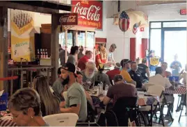  ?? / Kevin Myrick ?? Lunch was served to athletes and sponsors alike at the Cedartown Museum of CocaCola Memorabili­a ahead of the annual Wheelchair 5K on July 5.