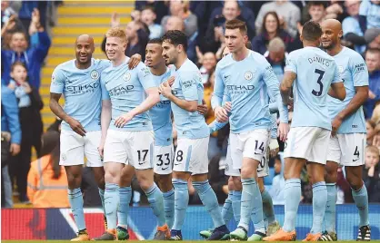  ?? Agence France-presse ?? Manchester City’s Kevin De Bruyne (second left) celebrates after scoring his team’s third goal during the English Premier League match against Swansea in Manchester on Sunday.