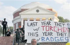  ?? AP ?? Protesters unveil a banner to mark the one-year anniversar­y of last year’s Unite the Right rally in Charlottes­ville on Saturday.