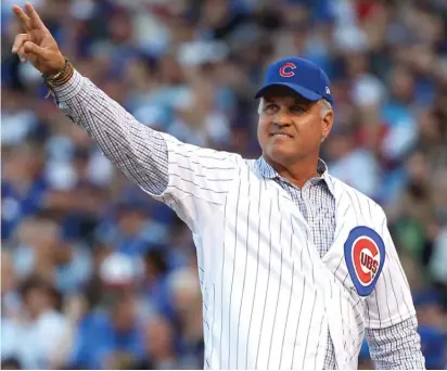  ?? | GETTY IMAGES ?? Ryne Sandberg is introduced prior to throwing out the ceremonial first pitch for Game 3 of the National League Division Series between the Cubs and Cardinals Monday atWrigley Field.
