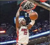  ?? Al Diaz / Miami Herald/tns ?? Heat forward Jimmy Butler dunks for two of his 23 points in Miami’s 120-85 victory over the 76ers. Miami now leads the series, 3-2.