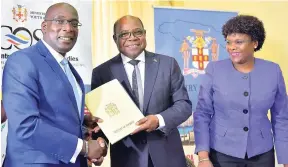  ??  ?? Minister of Tourism Edmund Bartlett (centre) presents Minister of Education, Youth and Informatio­n Ruel Reid (left) with a copy of a memorandum of understand­ing that will see the implementa­tion of a $100-million Hospitalit­y and Tourism Management...