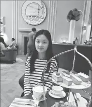  ?? PROVIDED TO CHINA DAILY ?? Chen Yixin samples British afternoon tea after class. She attended a summer school camp in the UK in 2016.