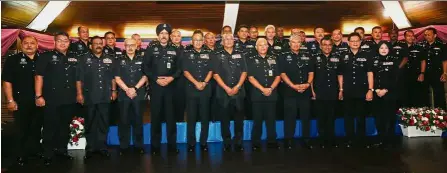  ??  ?? United they stand: Tan Sri Noor Rashid (front row, sixth right) posing for a photo with senior police officers after the rank awarding ceremony in Bukit Aman.