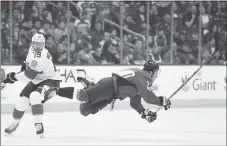  ?? NICK WASS — THE ASSOCIATED PRESS ?? The Capitals’ T.J. Oshie gets tripped by the Panthers’ Mike Matheson during Saturday night’s game.