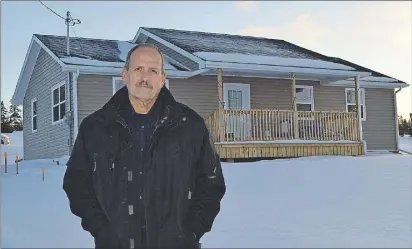  ?? SALLY COLE/THE GUARDIAN ?? Don Gray, constructi­on manager for Habitat for Humanity P.E.I., stands outside Bethany and Michael Robinson’s home in Harrington. It’s one of several built in the area by Habitat for Humanity P.E.I.