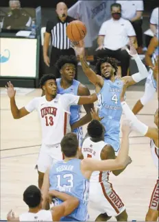  ?? AP photo ?? North Carolina’s RJ Davis leaps to shoot over UNLV’s Bryce Hamilton in the first half Monday.