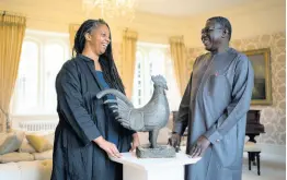  ?? AP PHOTOS ?? Master of Jesus College Sonita Alleyne, left and Director General of Nigeria’s National Commission for Museums and Monuments Professor Abba Isa Tijani pose for a photo ahead of a ceremony at Jesus College Cambridge, where the looted bronze cockerel, known as the Okukur, will be returned to Nigeria, in Cambridge, England.