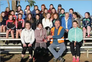  ??  ?? St. Mary’s (New Ross) receiving the Donna Foley Memorial Cup from Paddy Morgan (Wexford Athletics).