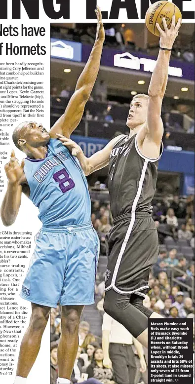  ?? AP ?? Mason Plumlee and Nets make easy work of Bismack Biyombo (l.) and Charlotte Hornets on Saturday when, without Brook Lopez in middle, Brooklyn totals 29 assists and hits 58% of its shots. It also misses only seven of 23 from 3-point land in second...