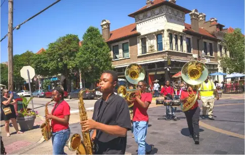  ??  ?? Members of the Normandy High School marching band perform a small parade in the Central West End, a St. Louis neighbourh­ood on the eastern edge of Forest Park.— Photos for The Washington Post by Matt Miller