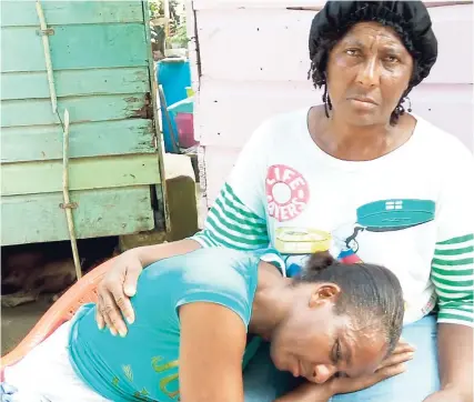  ??  ?? Nicko Campbell’s mother, Annett Calvin, is comforted by a relative.