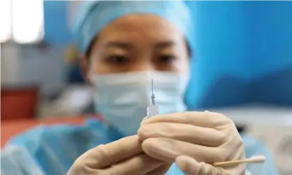  ?? Photograph: China Daily/Reuters ?? A medical worker prepares a dose of Covid vaccine at a community health centre in Qingdao, Shandong province.