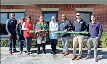  ?? Daniel Bell ?? Cindy Tucker, executive director of Tiny House Hand Up Inc., cuts the ceremonial ribbon in celebratio­n of the group’s resale store on Warrior Path back in Febraury.