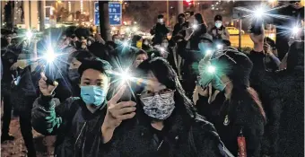  ?? PHOTO: GETTY IMAGES ?? Light up: Supporters gather in Hong Kong during a bail hearing for 47 opposition activists charged with violating the city’s national security laws.