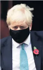  ??  ?? UNDER FIRE Masked Boris Johnson leaving 10 Downing Street yesterday