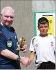  ??  ?? Arklow Town’s Shane Monaghan collects his Man of the Match award from referee Thomas ‘Tucker’ Dowling.