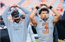  ?? PHIPPS/ THE OKLAHOMAN] [SARAH ?? OSU coach Mike Gundy and quarterbac­k Spencer Sanders sing the alma mater after a 24-21 win over Iowa State on Oct. 24.