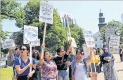  ?? THE CANADIAN PRESS/HO-STACEY GOMEZ ?? People hold up signs at a rally in Halifax on Saturday to protest an American policy that separated families who were caught crossing the U.S.-Mexico border.