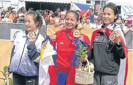  ??  ?? Women’s marathon champion Mary Joy Tabal of the Philippine­s, centre, is flanked by silver medallist Hoang Thi Thanh of Vietnam, left, and third-place finisher Thailand’s Natthaya Thanaronna­wat.