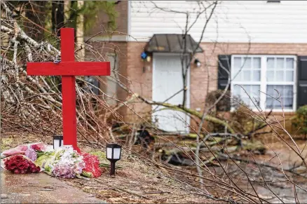  ?? JASON GETZ/JASON.GETZ@AJC.COM ?? A memorial for University of Georgia football player Devin Willock and UGA football team staff member Chandler LeCroy has been set up at the site where their vehicle crashed on Barnett Shoals Road in Athens. Two other passengers were injured.