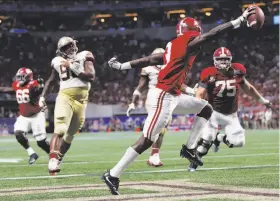  ?? John Bazemore / Associated Press ?? Alabama wide receiver Calvin Ridley scores on a two-point conversion during the top-ranked Tide’s victory over No. 3 Florida State in the season opener.