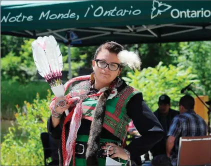  ?? CLIFFORD SKARSTEDT Examiner ?? Noelle Ewing wears a jingle dress during the closing song at a celebratio­n to mark National Aboriginal Day on Thursday at the Robinson Place provincial government building on Water St. National Aboriginal Day is held for all Canadians to celebrate the...