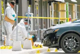  ?? COLE BURSTON/THE CANADIAN PRESS VIA AP ?? Members of a police forensic identifica­tion unit work near the site of an explosion Friday at a restaurant in Mississaug­a, Ontario.