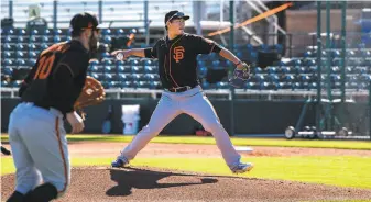  ?? Ash Ponders / Special to The Chronicle ?? Shun Yamaguchi throws during a bunt drill at practice at Scottsdale Stadium in Arizona. Yamaguchi thrived in 2019 for the Yomiuri Giants, as he went 164 with a 2.78 ERA.