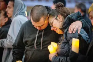  ?? GINO GUTIERREZ / JOURNAL ?? Two attendees comfort each other during a fentanyl awareness candleligh­t vigil at Civic Plaza in Downtown Albuquerqu­e in October.