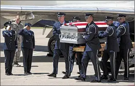  ?? Arkansas Democrat-Gazette/MITCHELL PE MASILUN ?? An honor guard carries the remains of Staff Sgt. Robert Dale Van Fossen from a plane Friday at Bill and Hillary Clinton National Airport/Adams Field for burial with military honors today at Heber Springs.