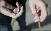  ?? ASSOCIATED PRESS FILE PHOTO ?? A fentanyl user holds a needle near Kensington and Cambria in Philadelph­ia. Suicides and drug overdoses helped lead a surge in U.S. deaths last year.