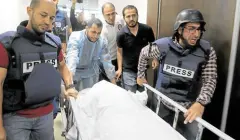  ?? —AFP ?? ‘BLATANT MURDER’ Colleagues escort the body of veteran Al Jazeera journalist Shireen Abu Aqleh, who was shot dead by Israeli troops as she covered a raid on the West Bank’s Jenin refugee camp on May 11.