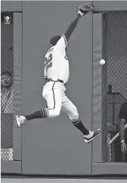  ?? THE ASSOCIATED PRESS ?? Atlanta Braves right fielder Nick Markakis cannot make a leaping catch in right field, allowing the Los Angeles Dodgers’ Chris Taylor a double during the fourth inning of Friday night’s game in Atlanta.