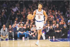  ?? Corey Sipkin / Associated Press ?? New York Knicks guard Dennis Smith Jr. (5) dribbles down court in the first half against the Brooklyn Nets on Sunday at Madison Square Garden in New York. Smith believes that the Knicks can turn around their season by fixing some discipline issues, especially in the fourth quarter.