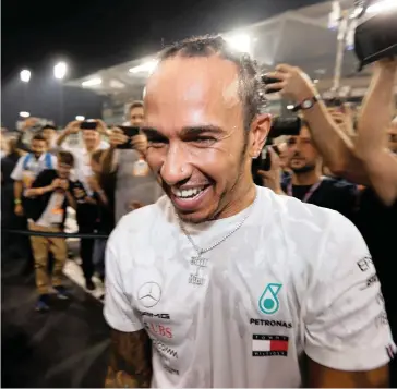  ?? REUTERS ?? LEWIS Hamilton celebrates his victory after the Abu Dhabi Grand Prix yesterday. |
