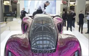  ?? DAVID MCNEW/GETTY IMAGES/AFP ?? A man polishes a 3D-printed car made by Divergent 3D, which is claimed to be a more environmen­tally friendly and cost-effective way to build cars, displayed during the four-day auto trade show AutoMobili­ty LA at the Los Angeles Convention Center on...